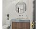 Powder room featuring a round mirror and a wood vanity with gold hardware at 4785 Merlendale Ct, Atlanta, GA 30327