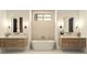 Bright bathroom with soaking tub, double vanity, modern fixtures, and decorative accents at 4785 Merlendale Ct, Atlanta, GA 30327