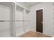 Spacious walk-in closet with custom shelving and wooden floors, offering ample storage at 4785 Merlendale Ct, Atlanta, GA 30327