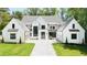 Stunning two-story home with a manicured lawn and a symmetrical facade showcasing a modern design at 4785 Merlendale Ct, Atlanta, GA 30327