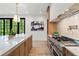 Kitchen showcasing a marble island, gas range, and plentiful cabinets at 4785 Merlendale Ct, Atlanta, GA 30327