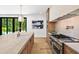 Close-up of a kitchen island, stainless steel range, and cabinetry, showcasing a modern design at 4785 Merlendale Ct, Atlanta, GA 30327