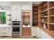 Elegant kitchen with stainless steel appliances, custom cabinetry, and a built-in beverage center at 4785 Merlendale Ct, Atlanta, GA 30327