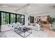 Bright living room with large windows, hardwood floors, and an open floor plan to the kitchen at 4785 Merlendale Ct, Atlanta, GA 30327