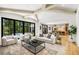 Bright living room with modern furniture, large windows, and hardwood floors in an open concept design at 4785 Merlendale Ct, Atlanta, GA 30327