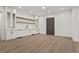 Open living room featuring hardwood floors, custom cabinets, shelving, and neutral decor at 4785 Merlendale Ct, Atlanta, GA 30327