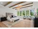 Bright main bedroom with beamed ceilings, large windows overlooking lush greenery and modern decor at 4785 Merlendale Ct, Atlanta, GA 30327