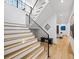 Staircase with wood steps, modern black railing, and decorative lighting, leading to the upper level at 4785 Merlendale Ct, Atlanta, GA 30327