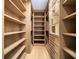 Spacious walk-in closet with wooden shelving and drawers for optimal organization and storage solutions at 4785 Merlendale Ct, Atlanta, GA 30327