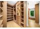 Expansive walk-in closet featuring custom shelving and a window bench for added convenience at 4785 Merlendale Ct, Atlanta, GA 30327
