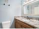 Bright bathroom features granite counters and a large vanity mirror, illuminated by modern lighting at 6700 Roswell Ne Rd # 25A, Sandy Springs, GA 30328
