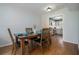 Dining area with hardwood floors, stylish table setting, and open view to the kitchen at 6700 Roswell Ne Rd # 25A, Sandy Springs, GA 30328