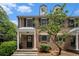 Charming brick townhome featuring black shutters, dormer windows, and a welcoming covered entrance at 6700 Roswell Ne Rd # 25A, Sandy Springs, GA 30328