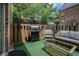 Charming patio area with an outdoor grill, comfortable seating, and green turf at 6700 Roswell Ne Rd # 25A, Sandy Springs, GA 30328
