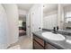 Bathroom featuring a granite countertop, sleek sink, and open doorway to an exercise area at 1181 Gateview Dr, Lawrenceville, GA 30046
