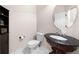 Bathroom features a unique basin sink with an oval mirror and tiled floors at 1181 Gateview Dr, Lawrenceville, GA 30046