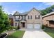 Charming two-story brick home featuring a well-maintained yard and two-car garage at 1181 Gateview Dr, Lawrenceville, GA 30046