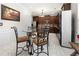Modern kitchen with stainless steel appliances, granite countertops, and a bar-style dining table at 1181 Gateview Dr, Lawrenceville, GA 30046