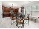 Bright kitchen featuring dark wood cabinets, a tiled floor, and a cozy dining area at 1181 Gateview Dr, Lawrenceville, GA 30046