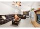 Comfortable living room features a ceiling fan and fireplace, open to the kitchen at 1181 Gateview Dr, Lawrenceville, GA 30046