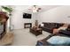 Comfortable living room featuring a fireplace, a ceiling fan, and a plush leather sofa at 1181 Gateview Dr, Lawrenceville, GA 30046