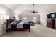 Spacious main bedroom features a ceiling fan, lounge chair, and ample natural light at 1181 Gateview Dr, Lawrenceville, GA 30046