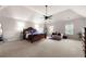 Spacious main bedroom features a ceiling fan, lounge chair, and ample natural light at 1181 Gateview Dr, Lawrenceville, GA 30046