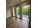 Bedroom featuring hardwood floors, a ceiling fan, three large windows, and access to a balcony at 1276 Longreen Terrace Nw # 115, Atlanta, GA 30318