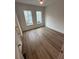Bedroom featuring hardwood floors, two large windows, and a ceiling fan at 1276 Longreen Terrace Nw # 115, Atlanta, GA 30318