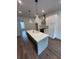 Kitchen with a large island, stainless steel appliances, white cabinetry, and hardwood floors at 1276 Longreen Terrace Nw # 115, Atlanta, GA 30318