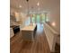 Kitchen with a large island, stainless steel appliances, white cabinetry, and hardwood floors at 1276 Longreen Terrace Nw # 115, Atlanta, GA 30318