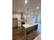 Kitchen with a large island, stainless steel appliances, white cabinetry, and hardwood floors at 1276 Longreen Terrace Nw # 115, Atlanta, GA 30318
