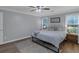 Bedroom with natural light, hardwood floors, ceiling fan and a minimalistic design at 141 Weatherstone Dr, Woodstock, GA 30188