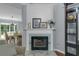 Elegant fireplace with white mantle and views of the dining area at 141 Weatherstone Dr, Woodstock, GA 30188