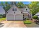 Inviting two-story home with two-car garage, traditional design, and landscaped front yard at 141 Weatherstone Dr, Woodstock, GA 30188