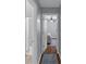 Hallway view to bathroom and bedroom with hardwood floors and neutral paint at 141 Weatherstone Dr, Woodstock, GA 30188