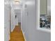 Bright hallway with hardwood floors and access to the kitchen and other rooms at 141 Weatherstone Dr, Woodstock, GA 30188