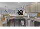 Kitchen with granite counters, stainless appliances, and open view to dining and living area at 141 Weatherstone Dr, Woodstock, GA 30188
