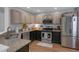 Modern kitchen with stainless steel appliances, granite countertops, and ample cabinet space at 141 Weatherstone Dr, Woodstock, GA 30188