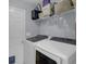 Laundry room featuring modern washer and dryer units, wire shelving and storage area at 141 Weatherstone Dr, Woodstock, GA 30188