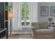 Comfortable living room with large bright window and cozy armchair at 141 Weatherstone Dr, Woodstock, GA 30188
