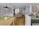 Open-concept living area adjoining kitchen and dining room with hardwood floors and natural light at 141 Weatherstone Dr, Woodstock, GA 30188