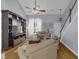 Spacious living room with high ceilings, custom shelving, and a window overlooking the yard at 141 Weatherstone Dr, Woodstock, GA 30188