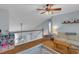 Loft area with hardwood floors, a comfortable seating area, and natural lighting at 141 Weatherstone Dr, Woodstock, GA 30188