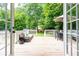 Outdoor deck with a seating area, dining table, and lush green backyard at 1486 Brooklyn Nw Ave, Atlanta, GA 30309