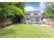 Lovely backyard featuring a lush lawn, mature trees, privacy fence, and spacious deck area at 1486 Brooklyn Nw Ave, Atlanta, GA 30309