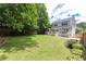 Large backyard with a lush lawn, wooden fence, and a deck perfect for outdoor enjoyment at 1486 Brooklyn Nw Ave, Atlanta, GA 30309