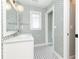 Charming bathroom featuring patterned wallpaper, tiled floors, and a vanity with a white countertop at 1486 Brooklyn Nw Ave, Atlanta, GA 30309