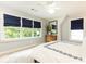 Serene bedroom with soft natural light, blue roman shades, and light hardwood floors at 1486 Brooklyn Nw Ave, Atlanta, GA 30309