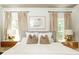 Well-lit bedroom showcasing two bedside tables with lamps and neutral decor at 1486 Brooklyn Nw Ave, Atlanta, GA 30309
